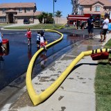 The neighborhood kids at Lemoore's Paradise Loop enjoyed an afternoon of hot dogs and water works with the Lemoore Volunteer Fire Department as volunteers held a sort of block party on Saturday.